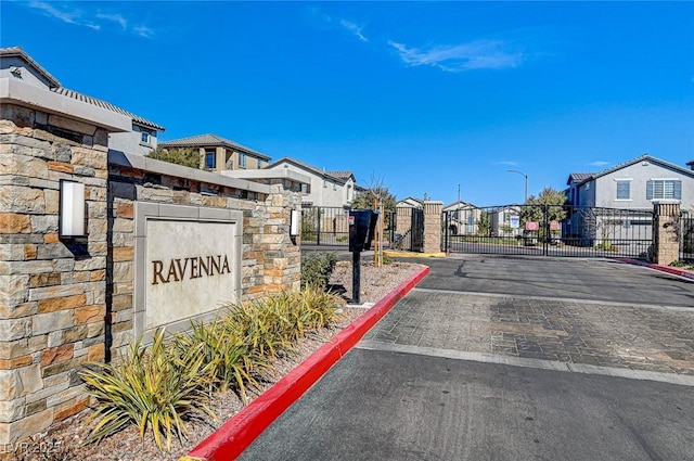 exterior space with curbs, a gated entry, a gate, and a residential view