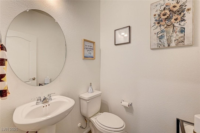 bathroom with toilet and a sink