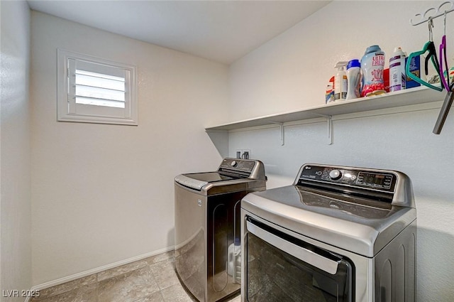 clothes washing area with laundry area, independent washer and dryer, and baseboards