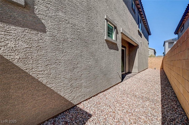 view of property exterior featuring a fenced backyard and stucco siding