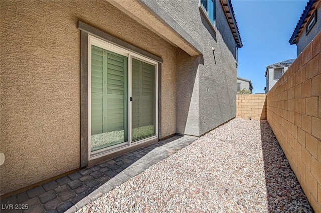 exterior space with a fenced backyard, a patio, and stucco siding