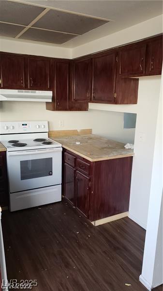 kitchen featuring dark wood-style floors, under cabinet range hood, light countertops, and electric range