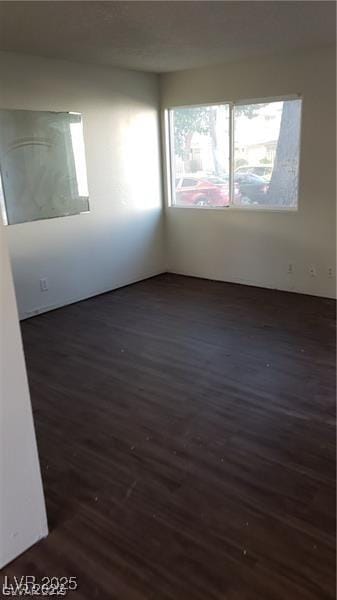 empty room featuring dark wood finished floors