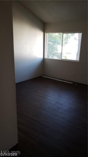 empty room with dark wood-style floors