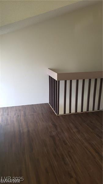 unfurnished room with dark wood finished floors