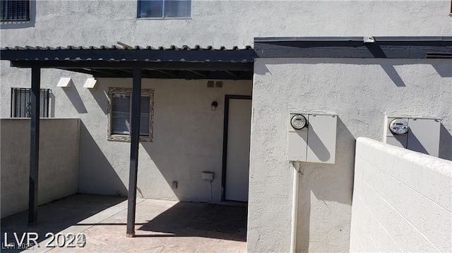 doorway to property with stucco siding