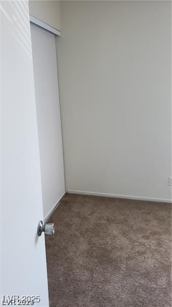 unfurnished room with carpet and baseboards