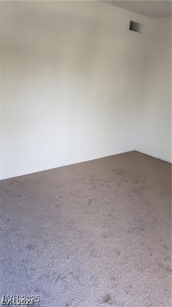 carpeted spare room with visible vents