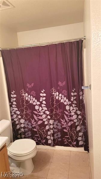 full bathroom featuring visible vents, a shower with shower curtain, toilet, vanity, and tile patterned floors