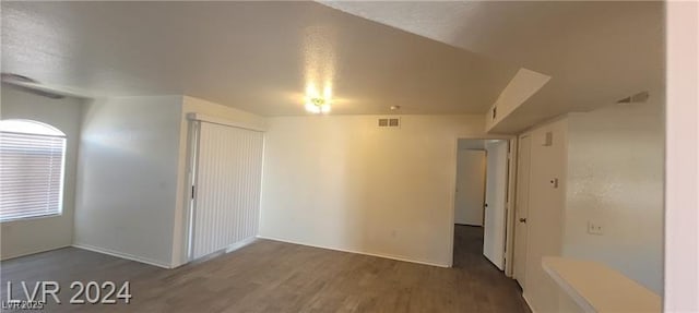 empty room featuring visible vents and wood finished floors