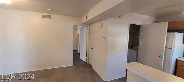 corridor with dark wood-style floors, baseboards, and visible vents