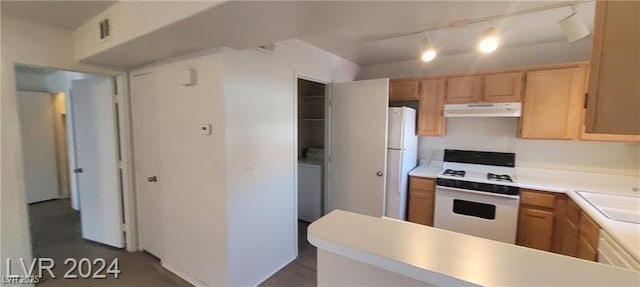 kitchen featuring light countertops, white appliances, washer / clothes dryer, and under cabinet range hood