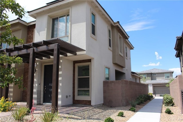 view of front of property featuring fence and stucco siding