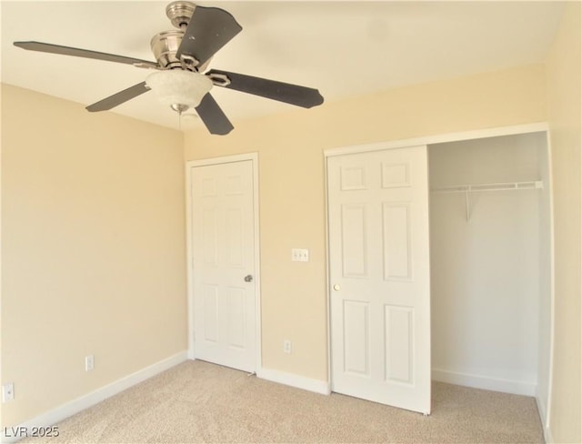 unfurnished bedroom with baseboards, ceiling fan, a closet, and light colored carpet