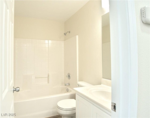 bathroom featuring tub / shower combination, vanity, and toilet