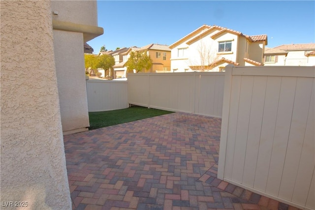 view of patio / terrace featuring a fenced backyard and a residential view