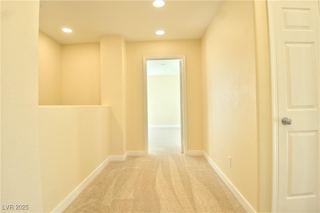 hallway with carpet floors, recessed lighting, and baseboards