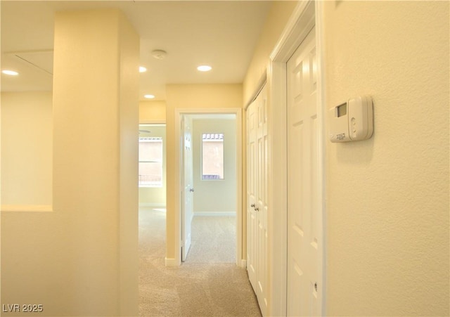 hallway featuring baseboards, carpet, and recessed lighting