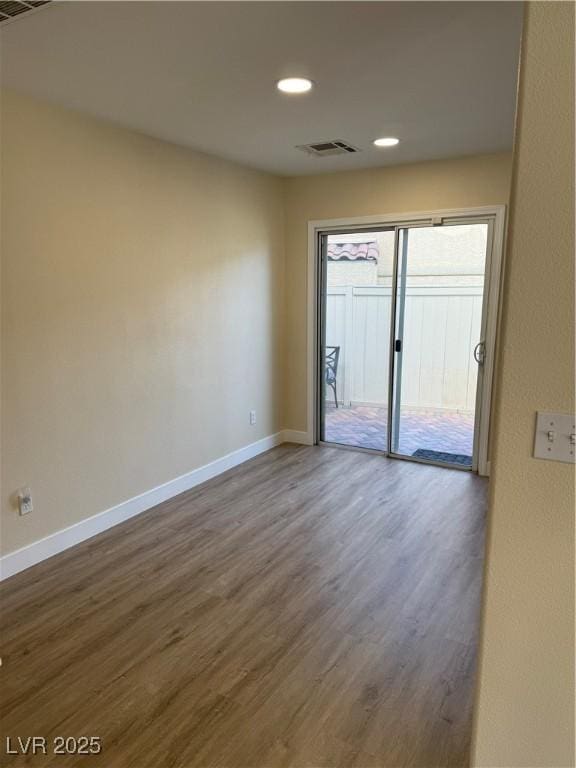 unfurnished room with recessed lighting, visible vents, baseboards, and wood finished floors