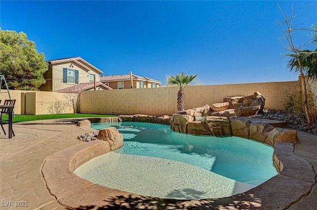 view of swimming pool featuring a fenced in pool, a patio area, and a fenced backyard