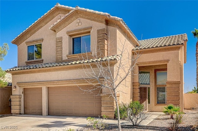 view of front facade with driveway, a tiled roof, an attached garage, and stucco siding