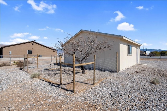 rear view of house with fence