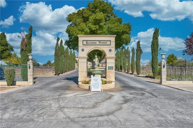 view of street featuring street lighting and a gated entry