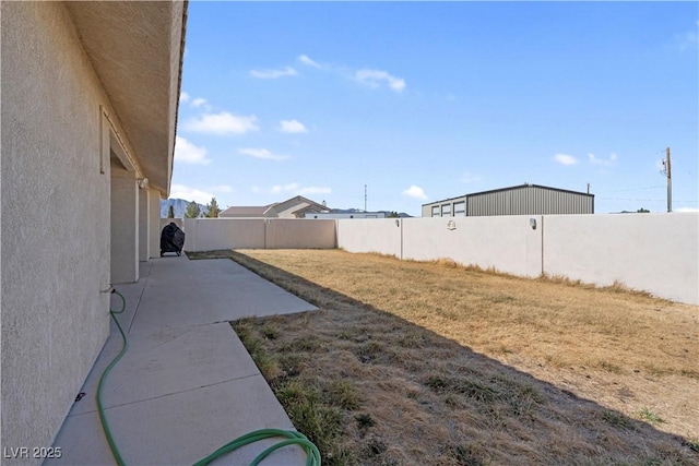 view of yard featuring a patio area and a fenced backyard