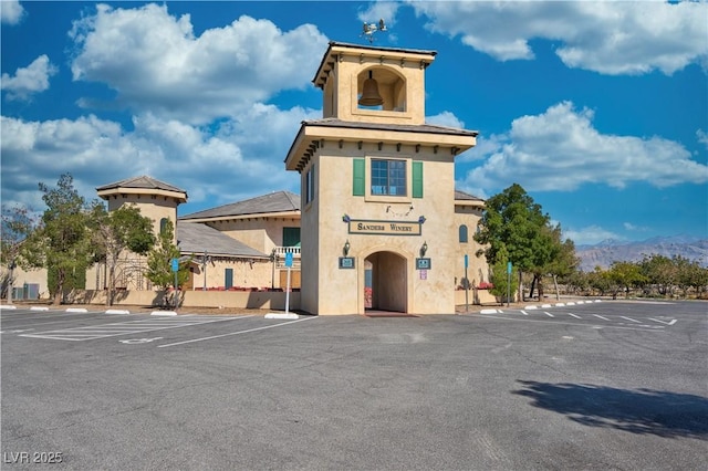 view of building exterior featuring uncovered parking