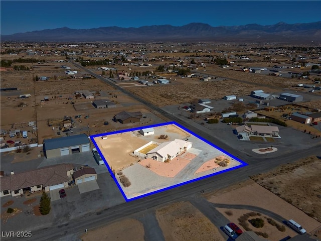 drone / aerial view featuring a desert view and a mountain view