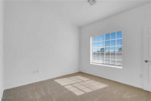 carpeted empty room with visible vents and baseboards