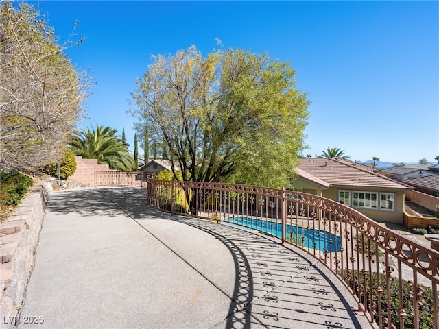 exterior space with a patio area, a swimming pool, and fence