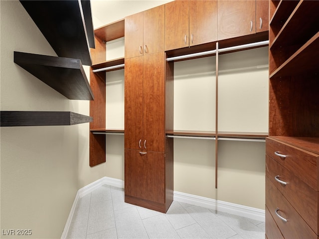 spacious closet featuring light tile patterned floors