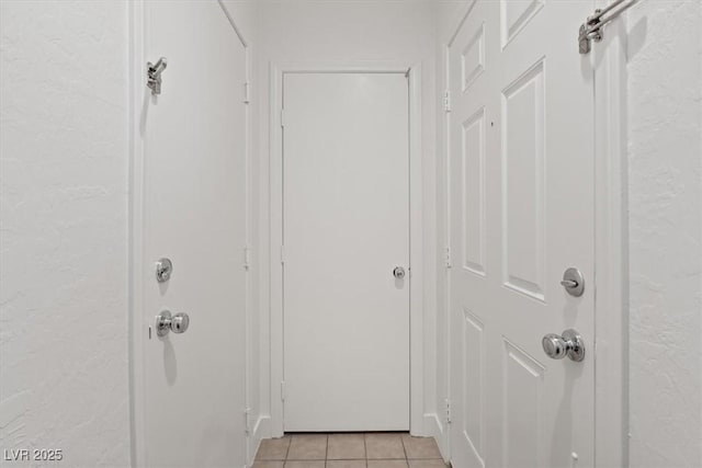 doorway with light tile patterned flooring