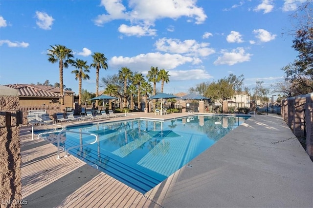 pool featuring a patio area and fence