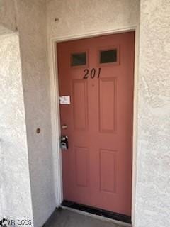 doorway to property with stucco siding