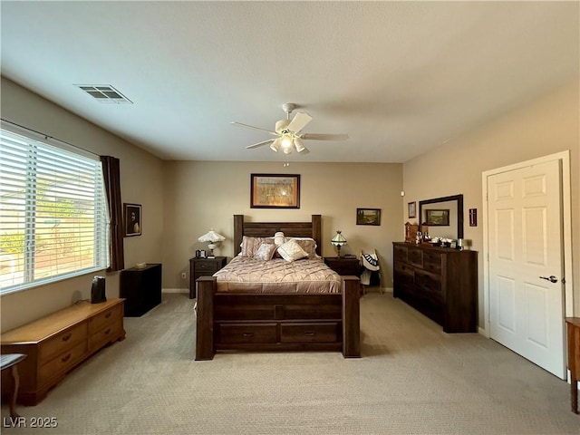 bedroom with light carpet, baseboards, visible vents, and ceiling fan