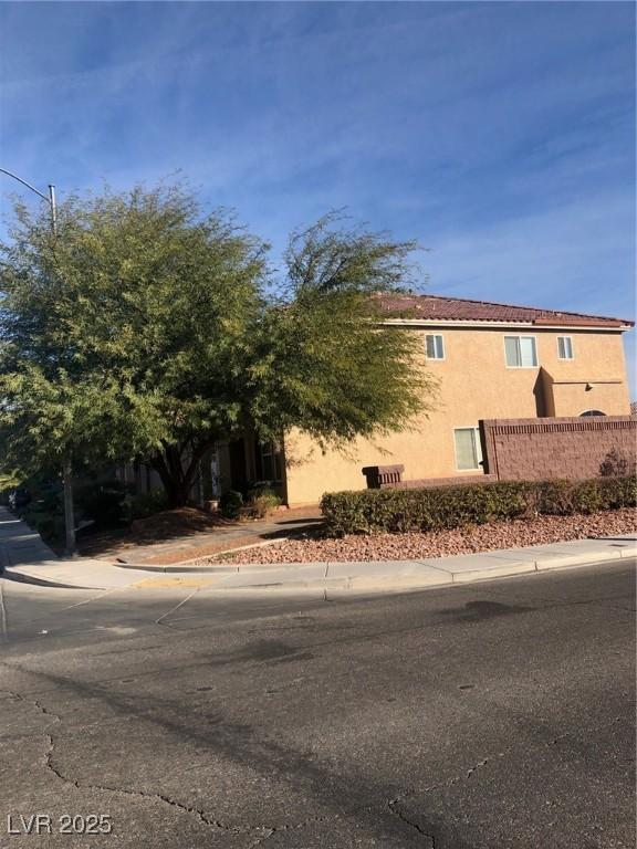 view of front of property with stucco siding and fence