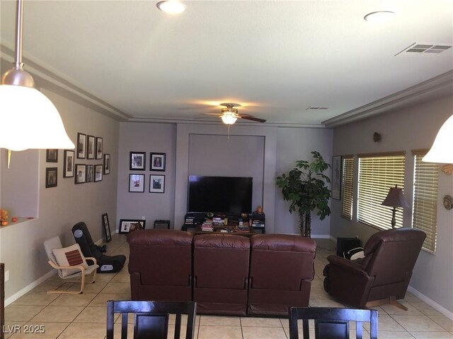 living room featuring light tile patterned floors, a ceiling fan, visible vents, and baseboards