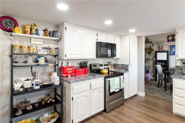 kitchen with black microwave, stainless steel electric range oven, light wood-type flooring, white cabinetry, and recessed lighting