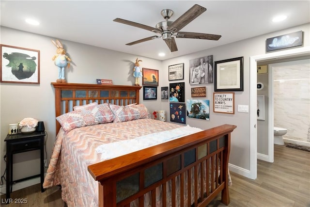 bedroom featuring recessed lighting, a ceiling fan, ensuite bath, wood finished floors, and baseboards