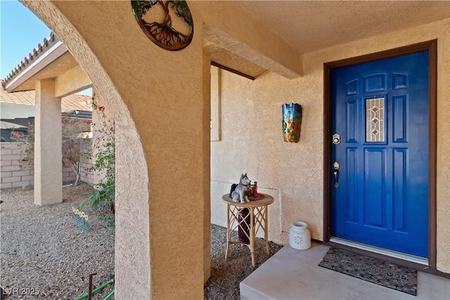 entrance to property with stucco siding