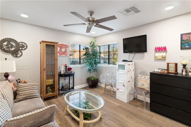 living area featuring light wood-style flooring, visible vents, and recessed lighting