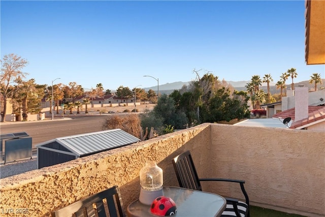 balcony featuring outdoor dining area and a mountain view