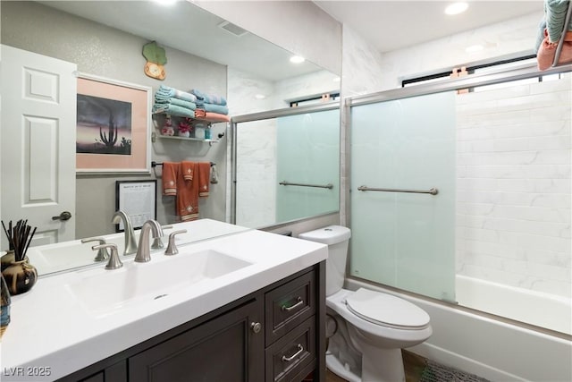 full bath with visible vents, combined bath / shower with glass door, vanity, and toilet