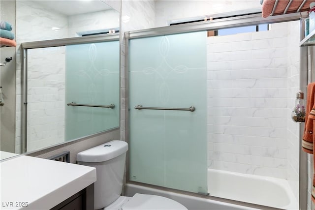 full bath featuring enclosed tub / shower combo, vanity, and toilet