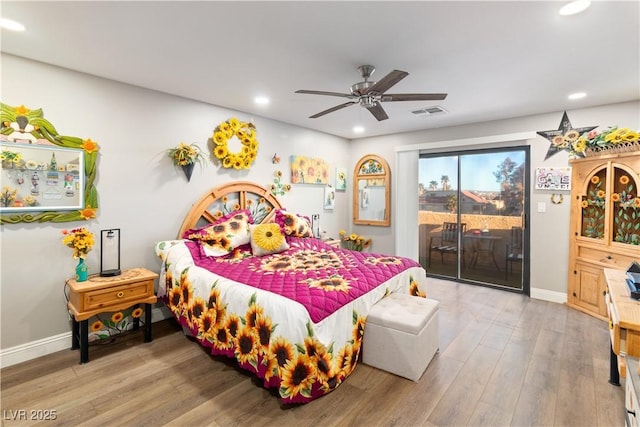 bedroom featuring access to exterior, visible vents, baseboards, and wood finished floors