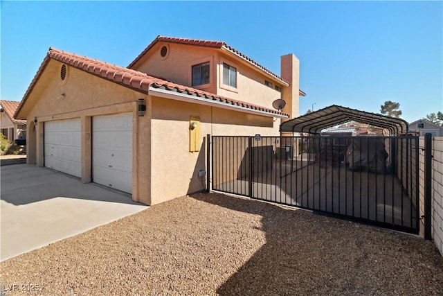 mediterranean / spanish-style home featuring stucco siding, concrete driveway, fence, a carport, and a tiled roof