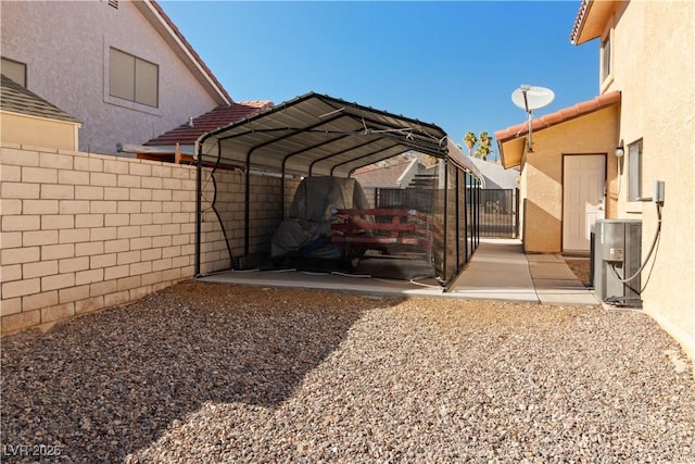 view of car parking featuring a carport, ac unit, and fence