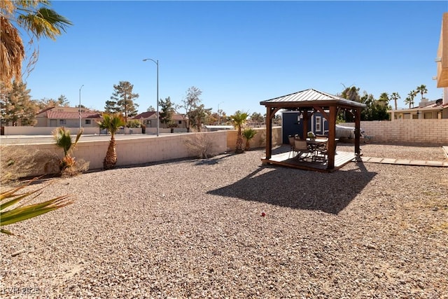 view of yard featuring a patio area, a fenced backyard, and a gazebo